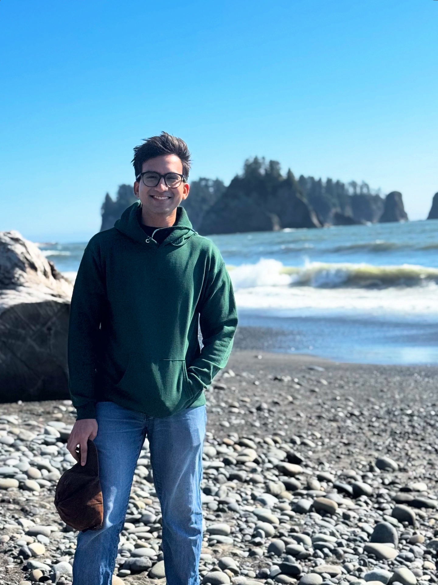 Abhishek standing on a rocky beach