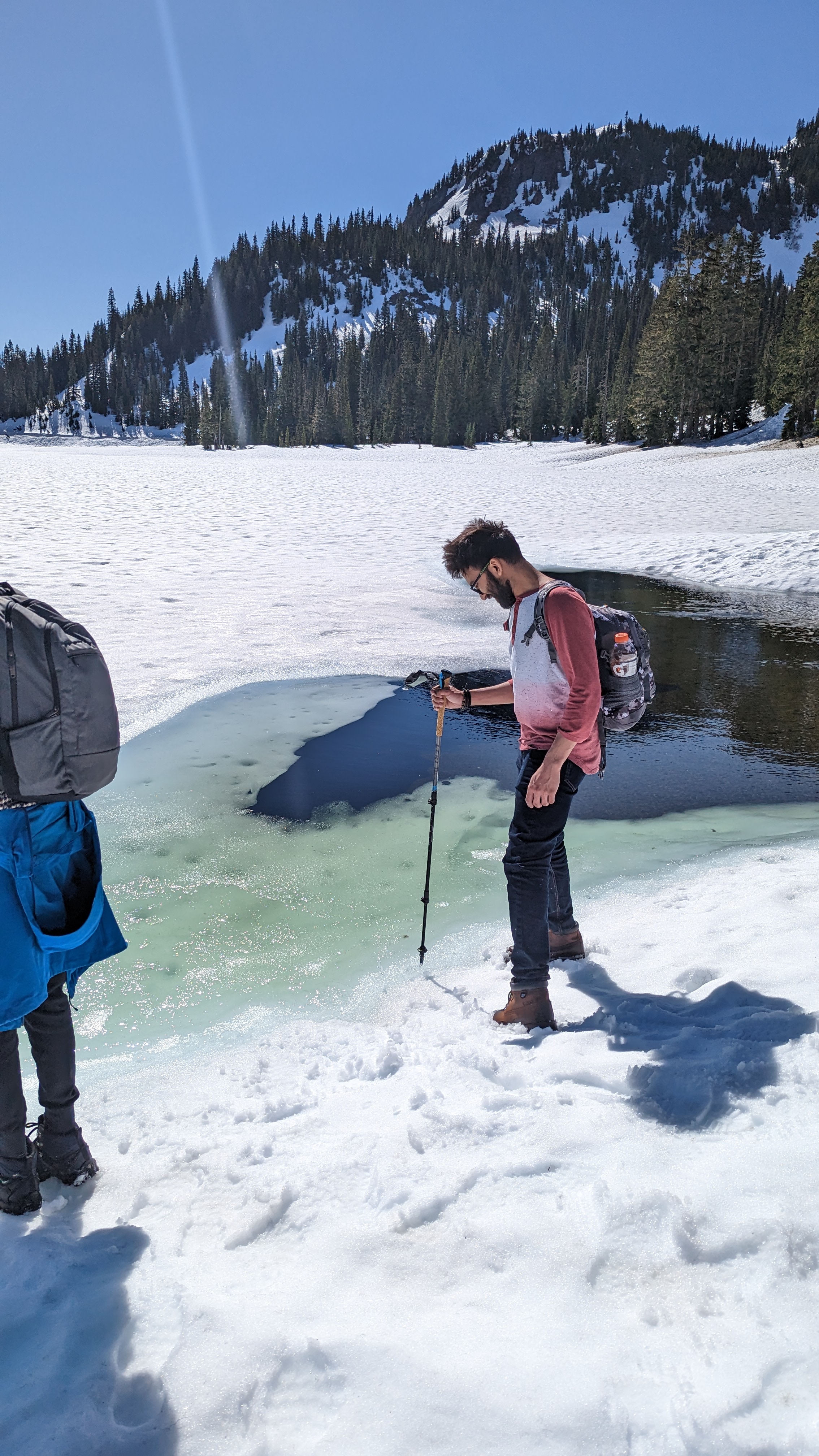 Abhishek near a snowy alpine lake
